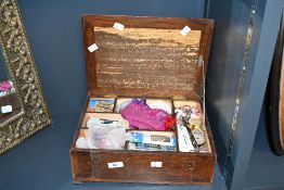 An early to mid 20th-century wooden sewing box, having a hinged lid, swing arm latch closing and