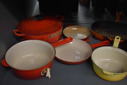 A selection of vintage and contemporary Le Crueset enamelled cast iron kitchenware, to include pots,
