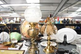 A large Victorian brass and glass converted oil lamp with a frosted and etched glass orb-formed