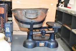 An early to mid 20th-century cast iron counter scales, featuring a removable metal weighing bowl,