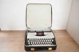 A mid 20th-century Olympia SF De Luxe portable typewriter, with original carry case, sold as seen.