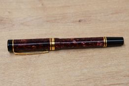 A Parker Duofold International Cartridge fill fountain pen in red swirl with one broad and one