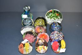 A selection of colourful 20th-century studio glass paperweights, to include a Mdina glass blue