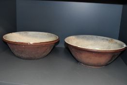 Two presumed Victorian earthenware pancheon bowls, having a glazed interior with a deep red unglazed
