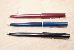 Three Parker 17 Jotter ballpoint pens in black,red and blue with gold trim