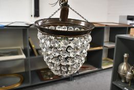 A contemporary small crystal cut glass 'bag'-style chandelier, featuring a metal ceiling chain