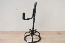 A thought to be late 18th-century wrought iron candle and rush light holder, featuring an upswept