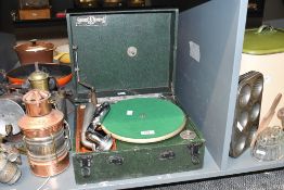 A vintage Golden Melody wind-up Gramophone, featuring a green case and turntable flet, marked to
