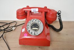 A 20th-century GPO-style red bakelite telephone, 15cm in height, marked to phone, condition is