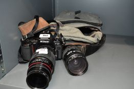 A Nikon F-801 SLR camera with AF Nikkor 28-85mm 1:3,5-4,5 lens and Sigma 1:4,4-5,6 75-300mm lens