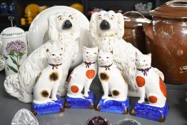 A pair of Staffordshire pottery spaniels, of traditional design with moulded detail and remains of