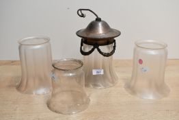 Three late 19th to early 20th-century frosted glass bell-shaped lampshades, to feature one example