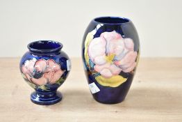 Two small 20th-century Moorcroft Pottery vases, to feature both 'Magnolia' and 'Anenome', having