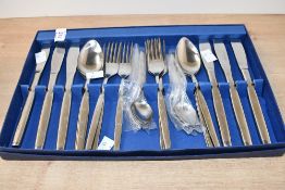 A boxed set of Vogue Connoiseur range stainless steel flatware and cutlery, with star designs to