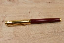 A Parker 75 converter fill fountain pen in burgundy laque with gold cap which has ruby coloured