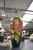 A large 20th-century Moorcroft Pottery 'Hibiscus' table lamp base, featuring colourful tube-lined