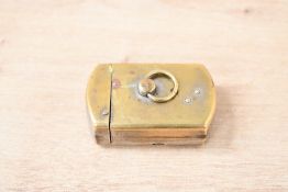 A small 20th-century German metal cigarette lighter, having a small brass ring that when turned pops