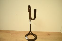 Thought to be late 18th-century wrought iron candle and rush light holder, featuring an upswept