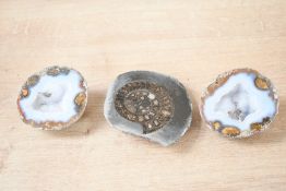 A small cut and polished ammonite fossil; sold with two split geode slice, thought to be agate, (3
