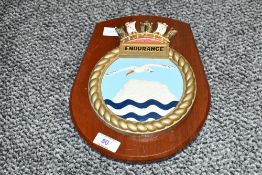 A 20th-century reproduction HMS Endurance ceramic plaque, having a wooden presentation board,