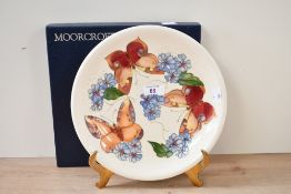 A 20th-century decorative Moorcroft Pottery 'Butterfly' plate, featuring tube-lined designs of