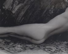 After John Swannell (British b.1946) Monochrome Photographic print, a nude reclined female on a