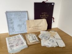 An antique portfolio case in deep burgundy with gold foiled lettering, ribbon fastenings,