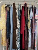 Assorted 1970s vintage outfits to include a paisley kaftan with velvet detail, two dress suits in