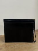 A vintage S.Launer & Co. Clutch bag in smooth black leather with gilt metal hardware, wrist loop,