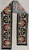 A large vintage hand-worked crewel work banner or table runner on black velvet ground, with floral
