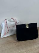 A vintage Salvatore Ferregamo clutch bag in black suede with snap-closure, gold metal monogrammed