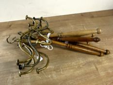 Six rotating gown and wig hangers, with brass hooks and wood handles.