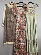 Three retro 20th century vintage British-made dresses in warm earth tones, comprising a full