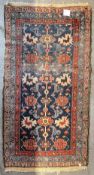 Antique hand knotted Persian rug, having a central floral design in red, purple, blue, green and