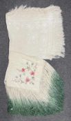 Two early 20th century shawls with elaborate fringing, one all over cream silk with floral