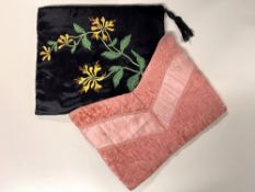 Two 20th century vintage clutch purses or pyjama wallets with padded walls, one black satin with