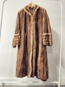A vintage De Bella Fashion Perfect Furs coat in golden brown gradient hide, with brown satin lining,