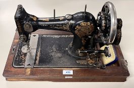 A vintage German Vesta hand-cranked boat shuttle sewing machine with original instruction manual, in