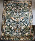 A room-size William Morris for Ruggable washable rug in the pictoral 'Strawberry Thief Indigo' birds