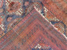 A Persian area rug in red wool with cream and brown accents, having a central tiled diamond gul