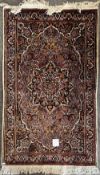 A hand knotted wool rug, possibly an Iranian Isfahan, having a central medallion design with