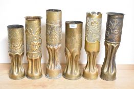 A group of six World War I and later brass trench art shell cases, each with embossed foliate