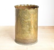 A large World War I French brass trench art shell case, having a ruffled rim over slightly