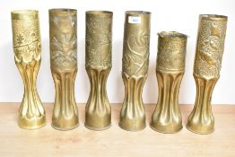 A group of six World War I and later brass trench art shell cases, each with embossed foliate