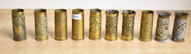 A group of ten World War I 37mm brass trench art shell cases, each with embossed, hand hammered or