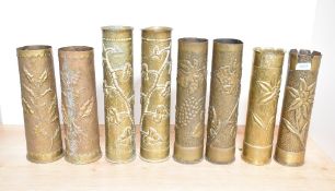 Four pairs of French and British brass World War I trench art shell cases, each embossed and hand
