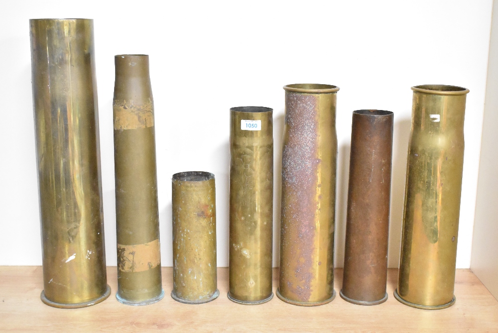 A group of seven British, French, German and American brass shell cases, pre-World war I, World