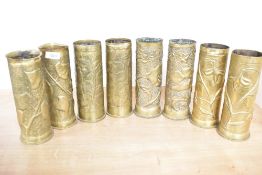 Four pairs of World War I German brass trench art shell cases, each embossed and hand hammered