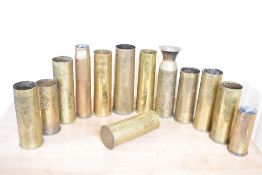 A group of thirteen British, French and German World War I and later brass trench art shell cases,