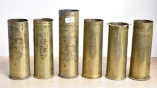 A group of six World War I brass trench art shell cases, one French and four German, each hand-